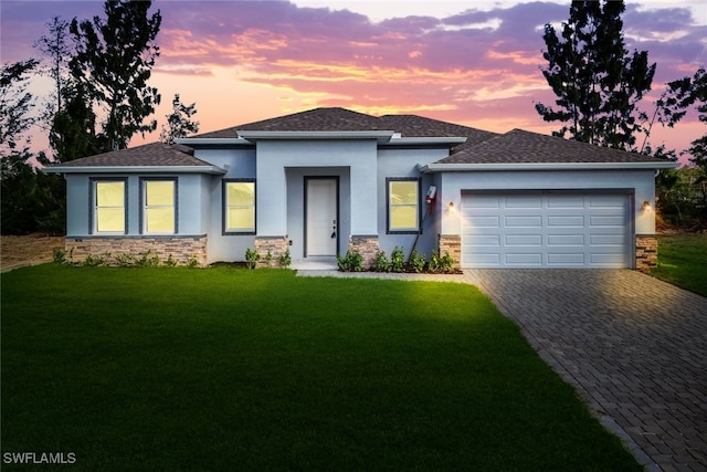 prairie-style house with a garage and a yard