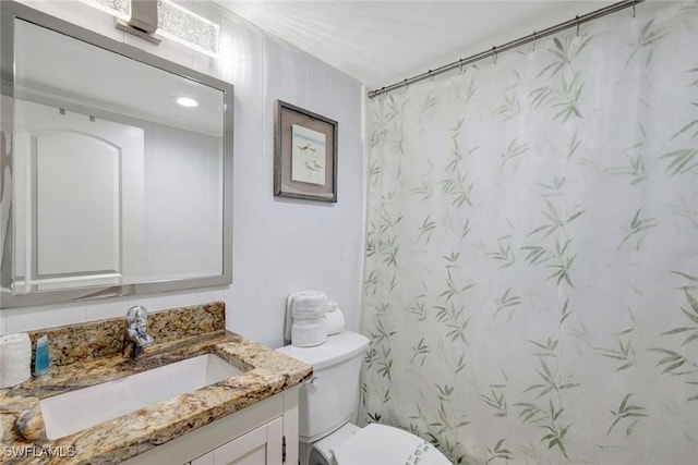 bathroom featuring vanity, a shower with shower curtain, and toilet