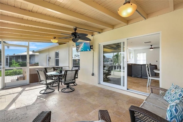 sunroom featuring beam ceiling, ceiling fan, and wooden ceiling