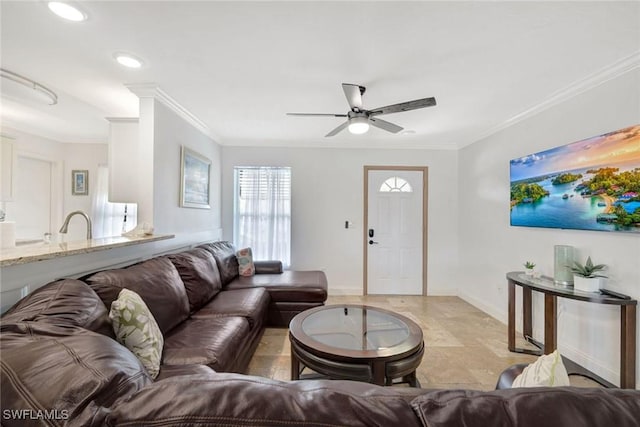 living room with ceiling fan and ornamental molding