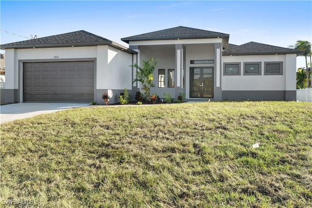 prairie-style house with a garage and a front lawn