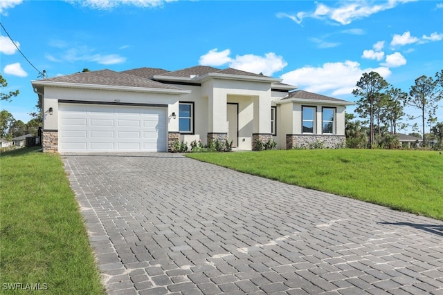 prairie-style home with a garage and a front lawn