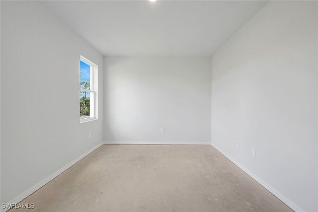 empty room with concrete flooring