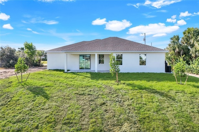 rear view of property with a yard