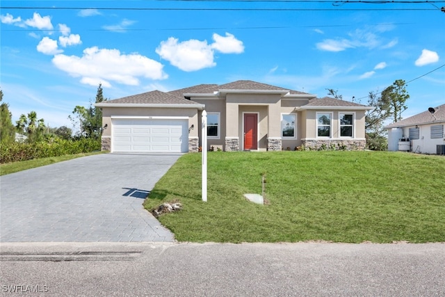 view of front of home featuring a garage and a front lawn