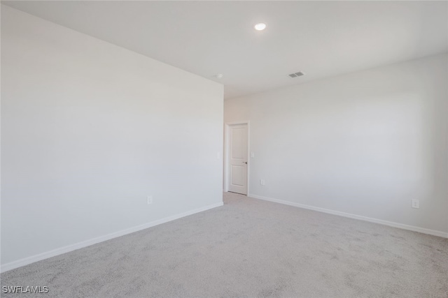 unfurnished room with light colored carpet