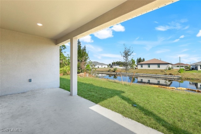 view of patio with a water view