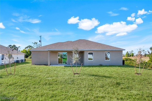 back of property featuring a lawn