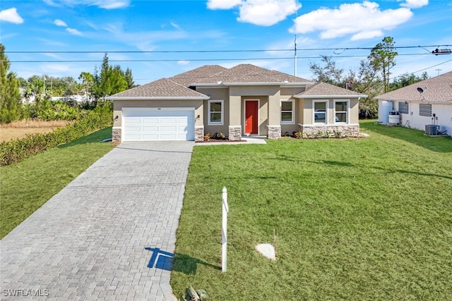 view of front of property with central AC, a garage, and a front lawn