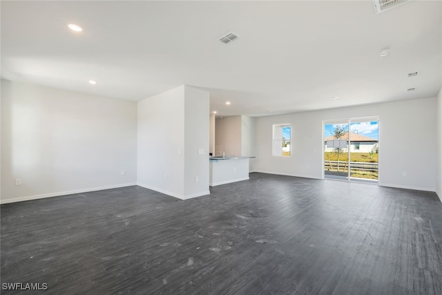 unfurnished living room featuring dark wood-type flooring