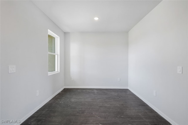 spare room featuring dark wood-type flooring