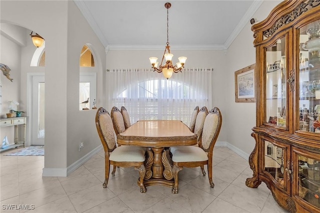 dining area featuring light tile patterned flooring, ornamental molding, and an inviting chandelier