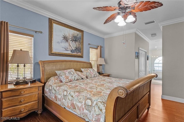 bedroom featuring multiple windows, hardwood / wood-style floors, ceiling fan, and ornamental molding