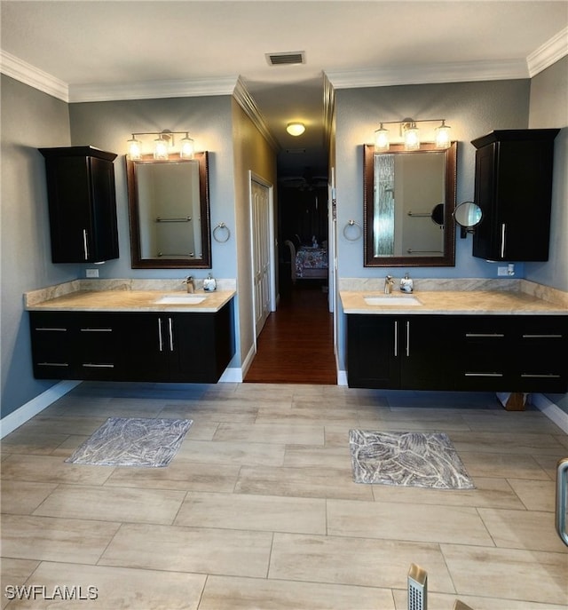 bathroom with wood-type flooring, vanity, and crown molding