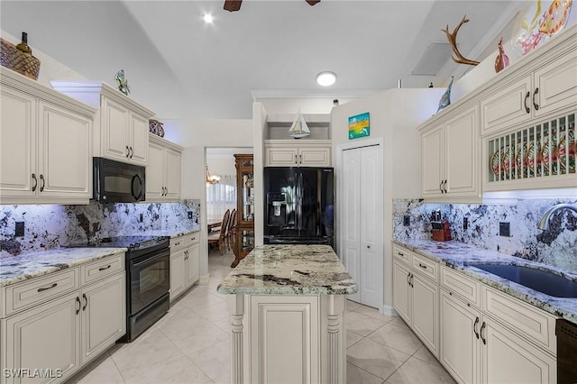 kitchen featuring black appliances, light stone countertops, sink, and tasteful backsplash