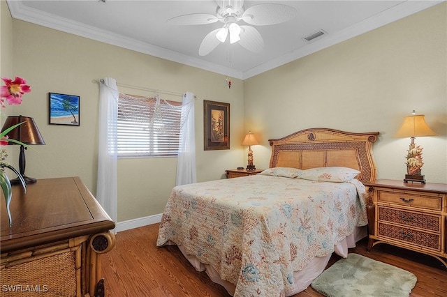 bedroom with ceiling fan, crown molding, and hardwood / wood-style flooring