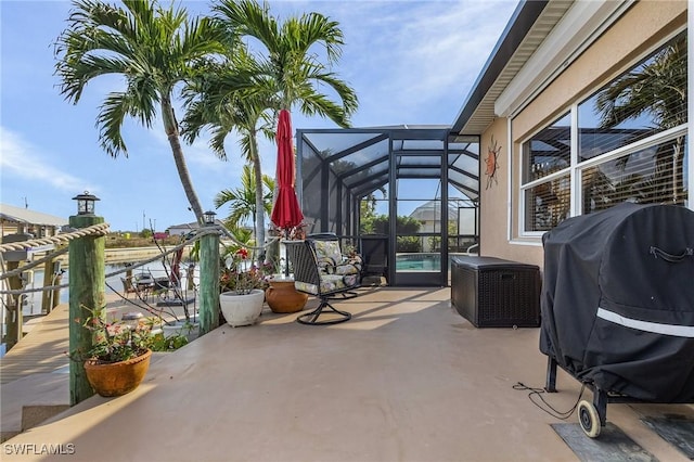 view of patio with a lanai and a grill