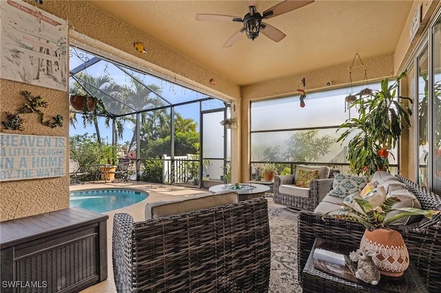 sunroom featuring ceiling fan and a pool with hot tub