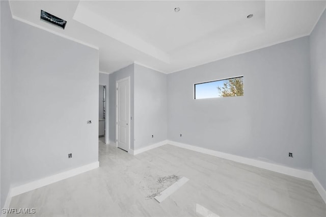 empty room featuring a raised ceiling