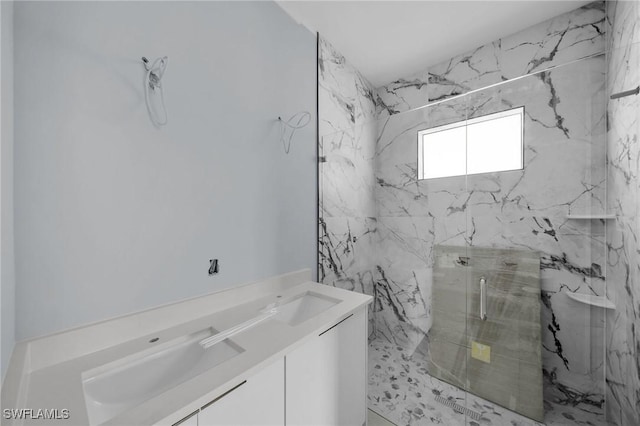 bathroom with vanity and a shower with shower door