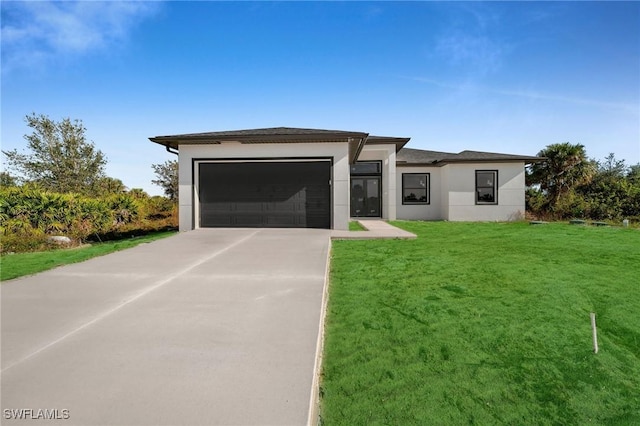 view of front of property featuring a garage and a front yard