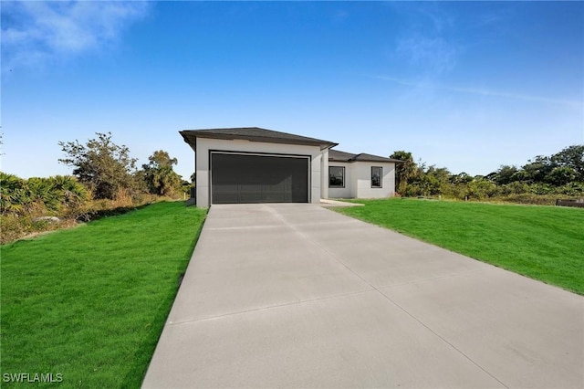 view of front of property featuring a front lawn and a garage