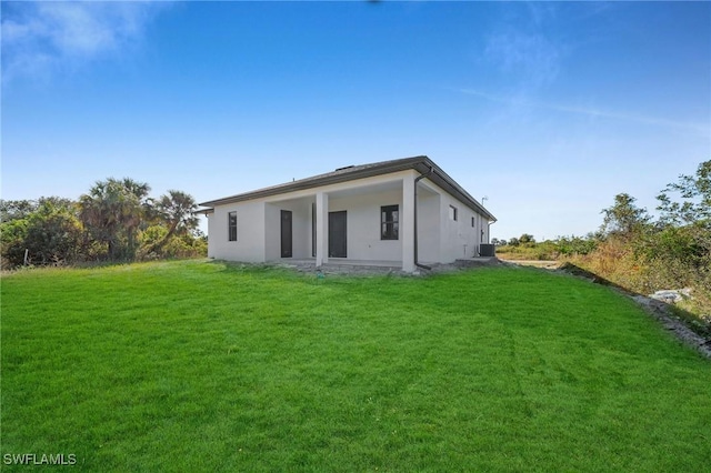 rear view of property with a lawn