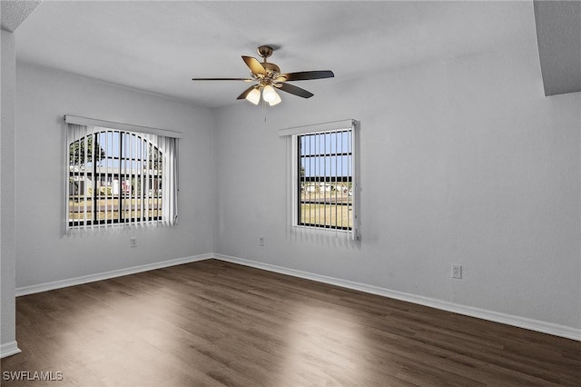 unfurnished room featuring dark hardwood / wood-style floors and ceiling fan