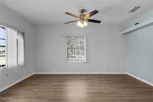 spare room featuring ceiling fan and dark hardwood / wood-style flooring