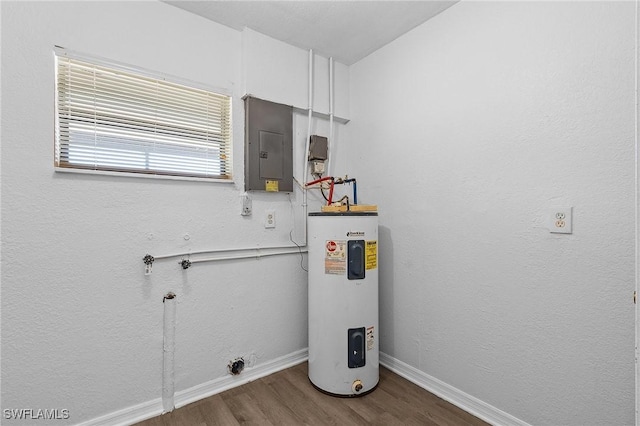 utility room featuring electric panel and water heater