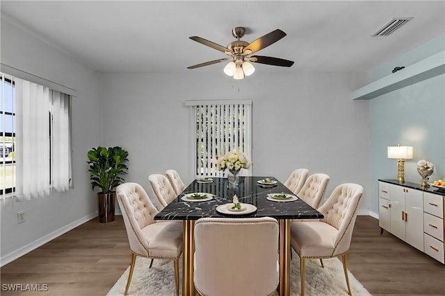 dining room featuring wood-type flooring and ceiling fan