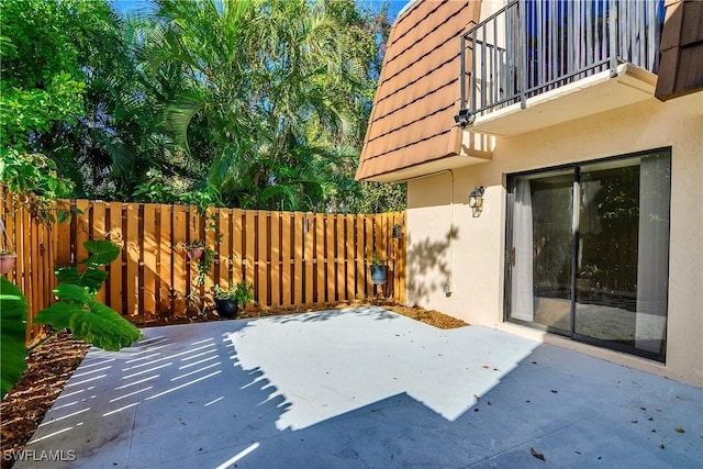 view of patio featuring a balcony