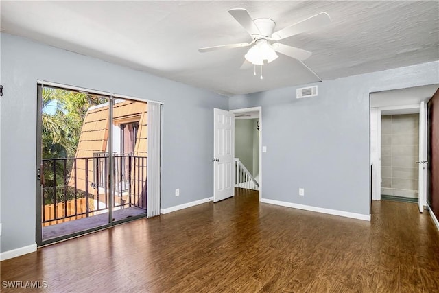 empty room with visible vents, ceiling fan, baseboards, and wood finished floors