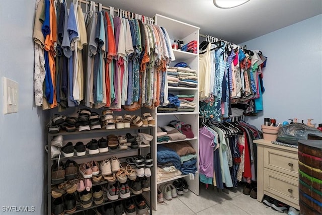 spacious closet with tile patterned floors