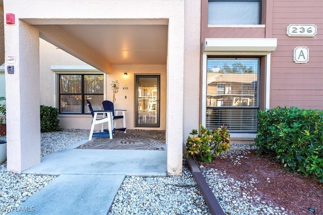 property entrance with stucco siding