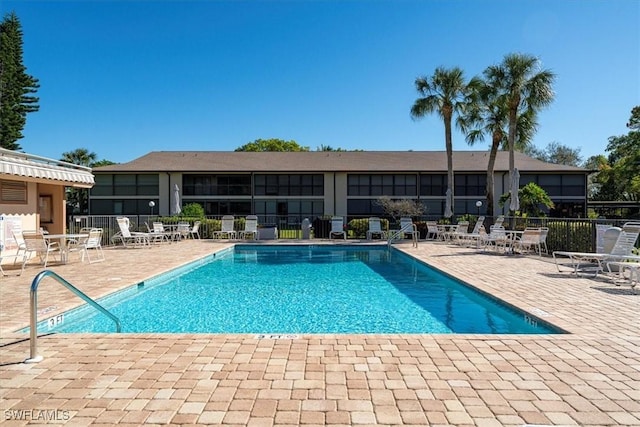 pool featuring a patio area and fence