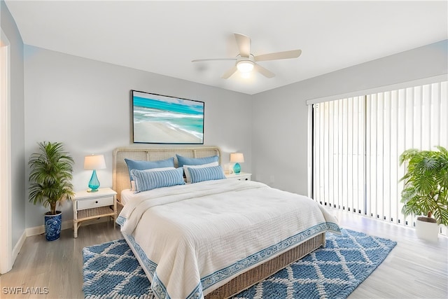 bedroom featuring ceiling fan, baseboards, and wood finished floors