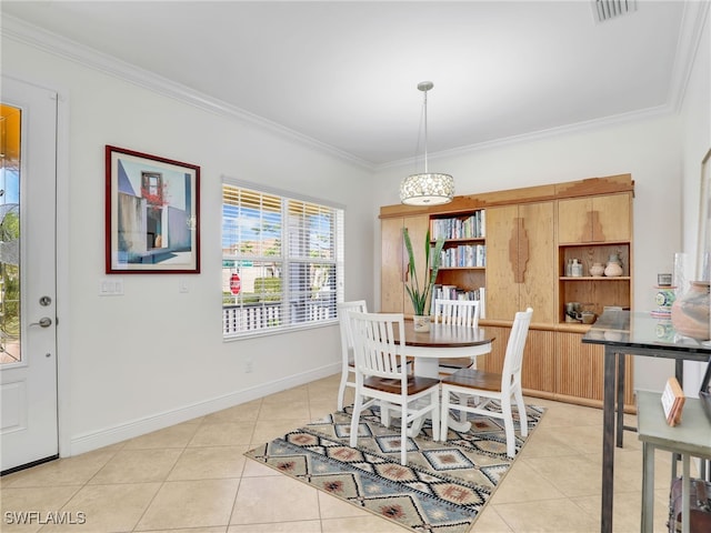 dining area featuring ornamental molding and light tile patterned flooring