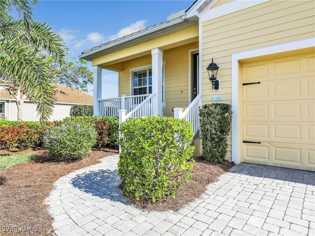 view of exterior entry with a porch