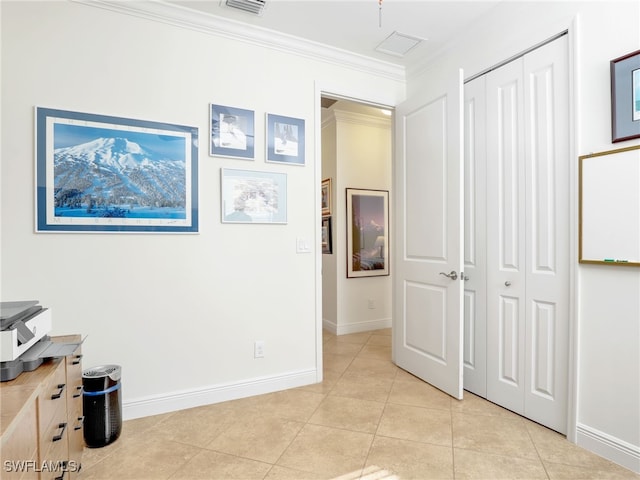 interior space featuring light tile patterned floors, ornamental molding, and a closet