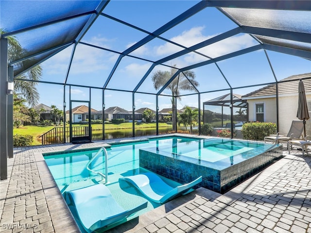 view of pool with glass enclosure, an in ground hot tub, a patio area, and a water view