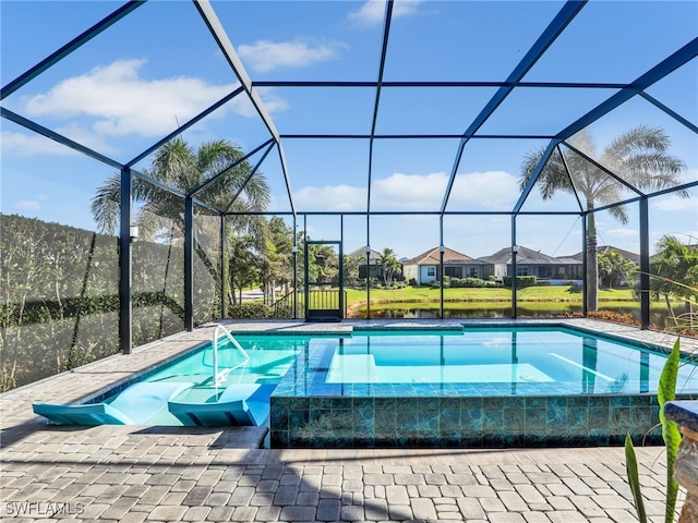 view of pool with glass enclosure and a patio area