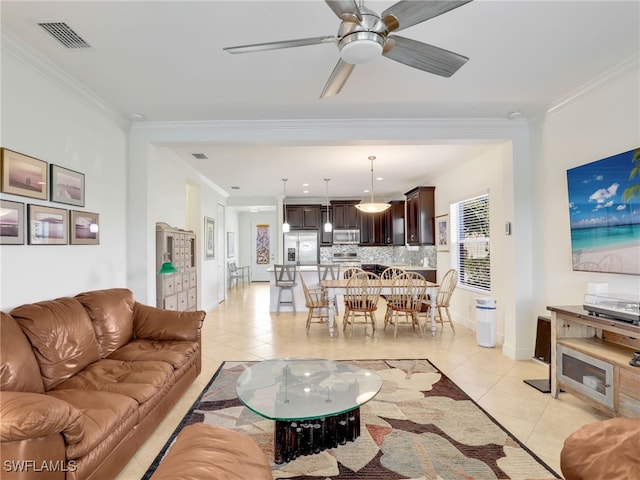 living room featuring ceiling fan, light tile patterned flooring, and ornamental molding