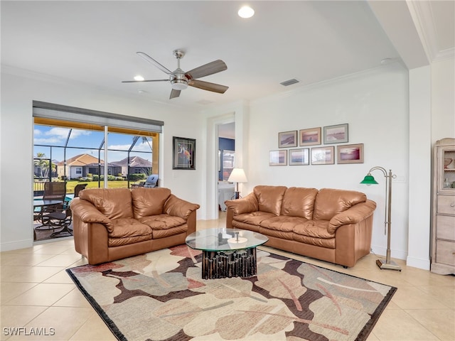 living room featuring ceiling fan, light tile patterned floors, and crown molding