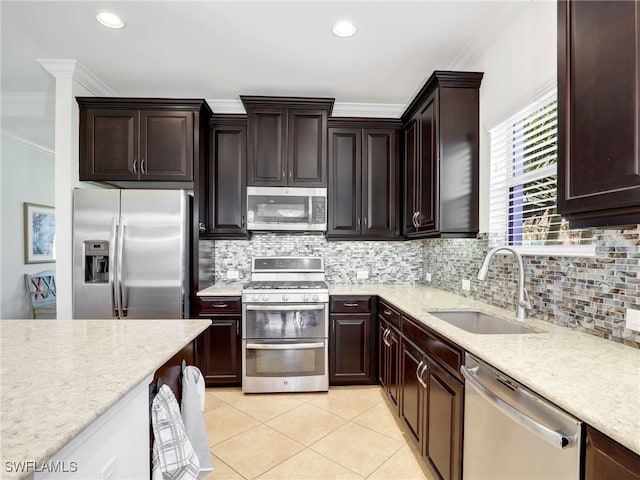 kitchen featuring sink, ornamental molding, stainless steel appliances, and tasteful backsplash