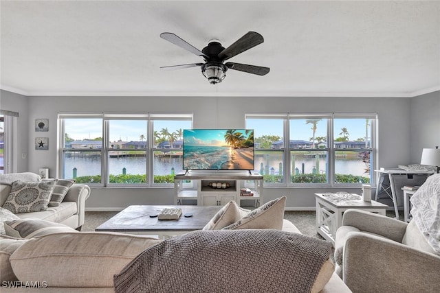 carpeted living room with a wealth of natural light, ceiling fan, and ornamental molding