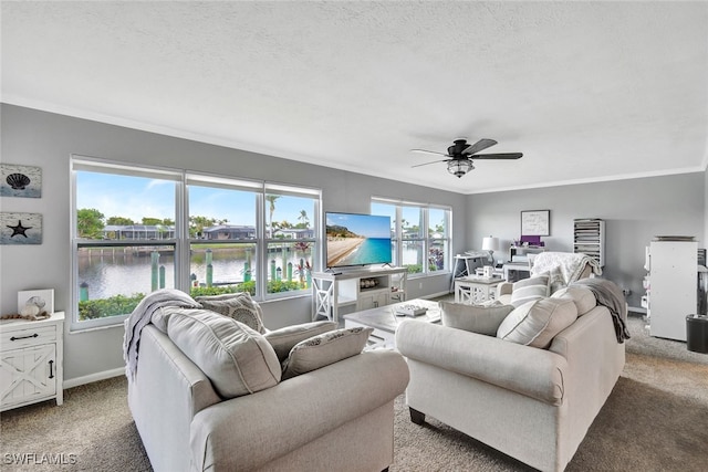 living room featuring light carpet, a textured ceiling, ceiling fan, and ornamental molding