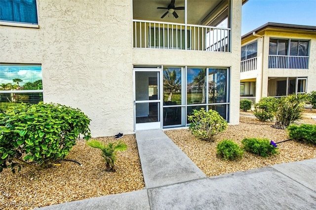 doorway to property featuring ceiling fan