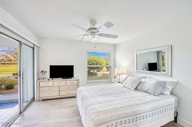 bedroom featuring access to exterior, ceiling fan, and light hardwood / wood-style floors