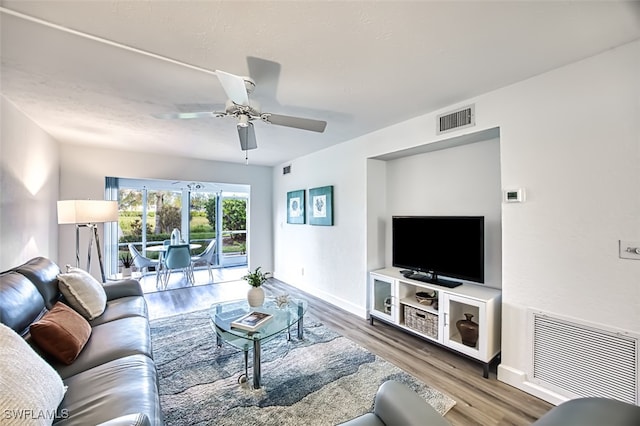 living room featuring hardwood / wood-style floors and ceiling fan